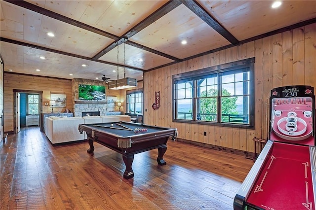 game room featuring billiards, a stone fireplace, wooden walls, hardwood / wood-style flooring, and ceiling fan