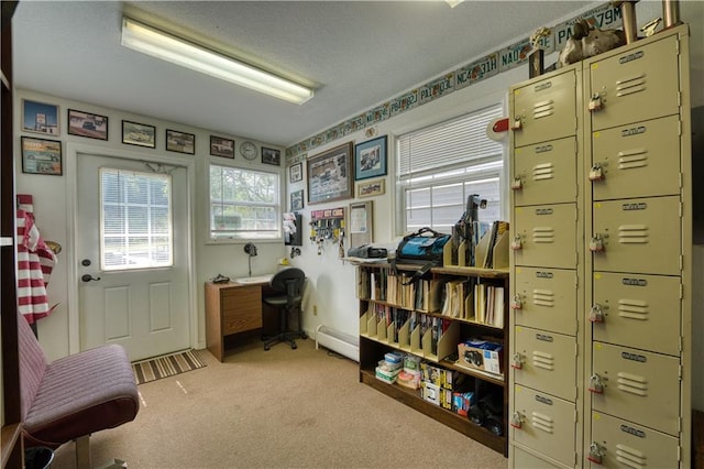 office with a textured ceiling, baseboard heating, and light colored carpet