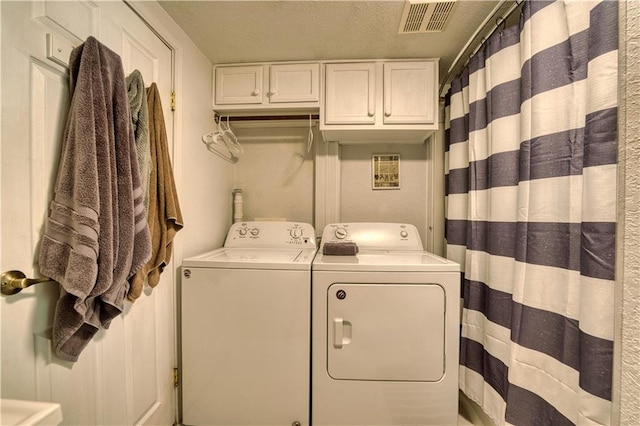 washroom featuring a textured ceiling and independent washer and dryer