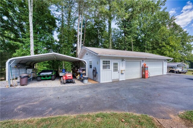 exterior space with an outdoor structure, a garage, and a carport