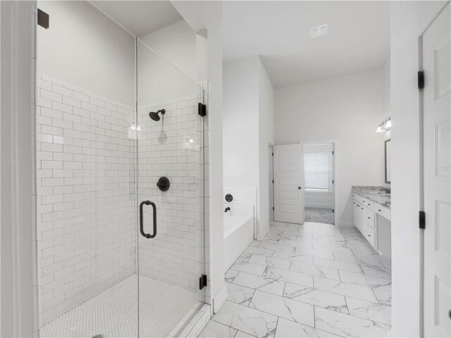 full bathroom with marble finish floor, a garden tub, vanity, and a shower stall