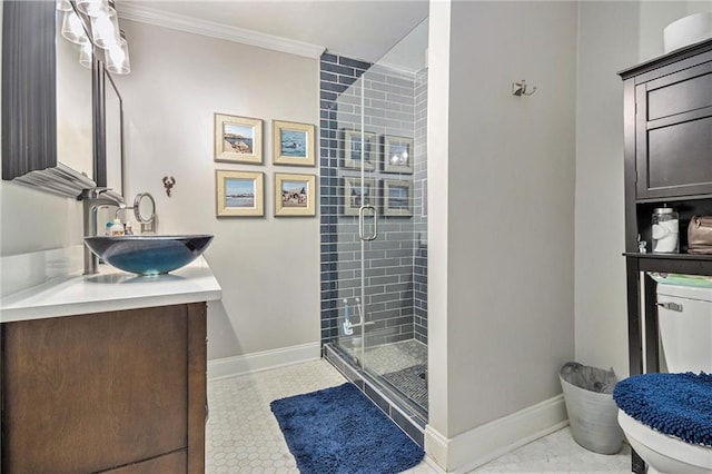 bathroom featuring a stall shower, vanity, baseboards, toilet, and ornamental molding