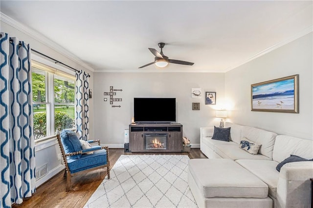 living area with crown molding and wood finished floors