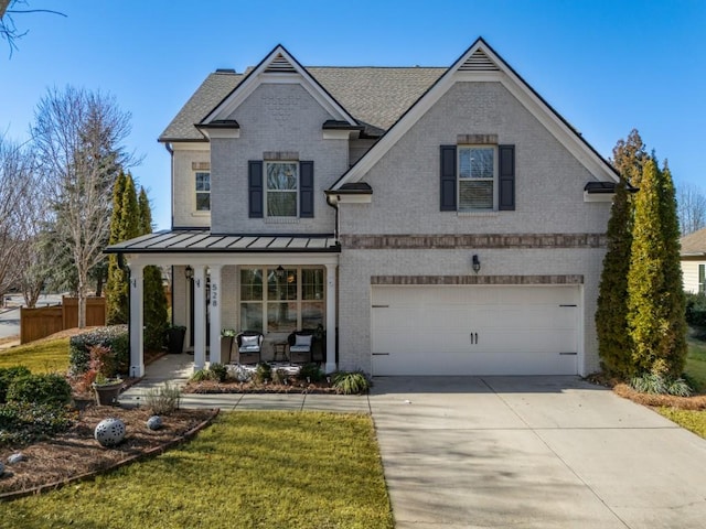 view of front of home featuring a garage, a front lawn, and a porch