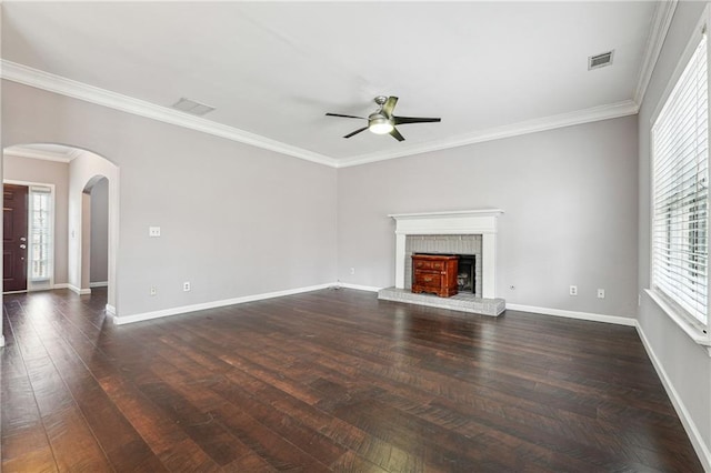 unfurnished living room featuring visible vents, wood finished floors, arched walkways, baseboards, and ceiling fan