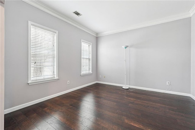 unfurnished room with visible vents, crown molding, baseboards, and hardwood / wood-style flooring