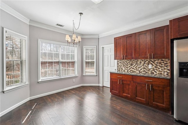 kitchen with visible vents, decorative backsplash, an inviting chandelier, stainless steel fridge, and dark wood-style flooring