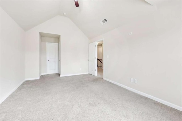 unfurnished bedroom with ceiling fan, lofted ceiling, and light carpet