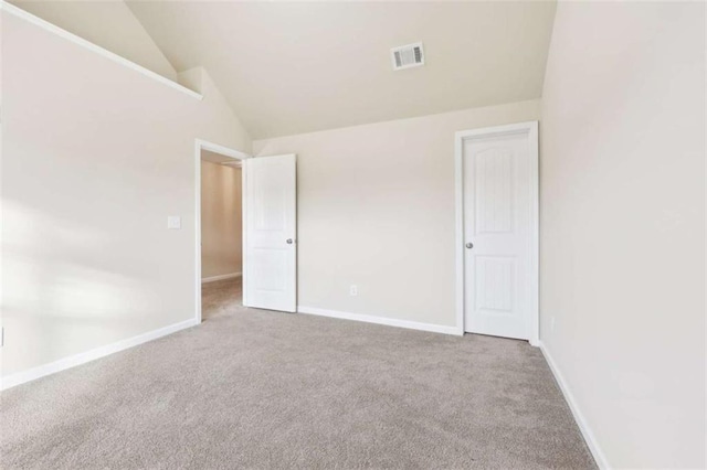 unfurnished bedroom featuring carpet and high vaulted ceiling