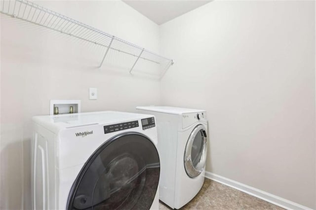 clothes washing area featuring separate washer and dryer