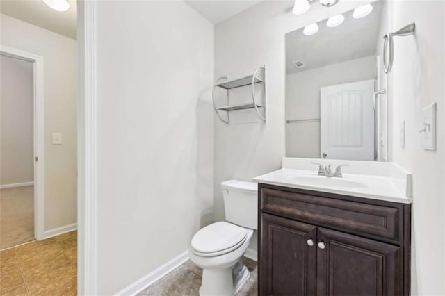 bathroom featuring tile patterned floors, vanity, and toilet