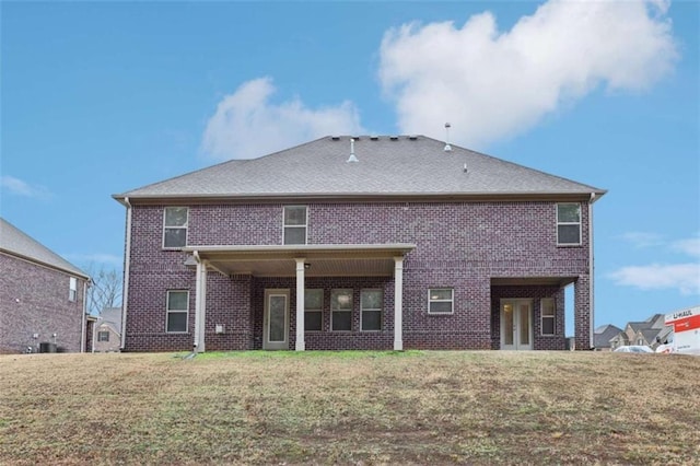 back of house featuring a yard