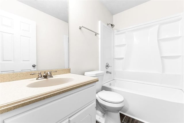 full bathroom featuring vanity, hardwood / wood-style flooring, shower / bathtub combination, and toilet