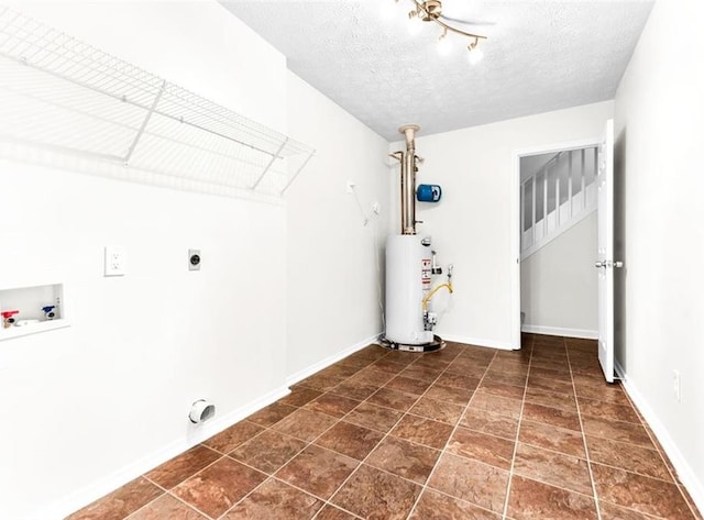 laundry room featuring water heater, washer hookup, hookup for an electric dryer, and a textured ceiling