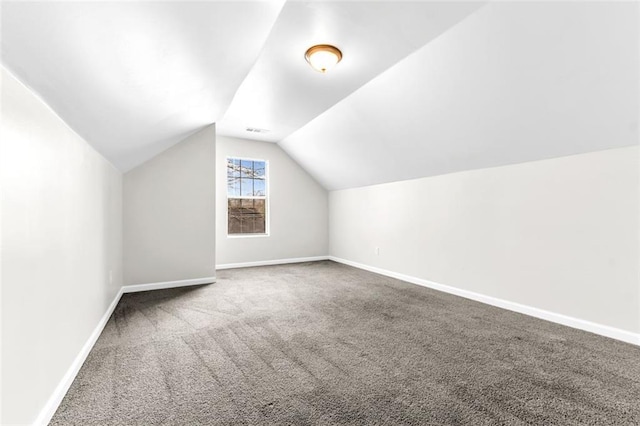 bonus room with lofted ceiling and carpet