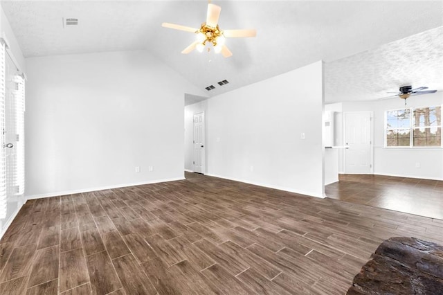 unfurnished living room with dark hardwood / wood-style flooring, lofted ceiling, and ceiling fan