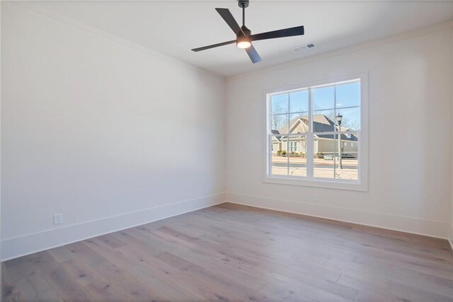 unfurnished room with ornamental molding, light hardwood / wood-style floors, and ceiling fan