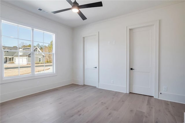 unfurnished bedroom with crown molding, light hardwood / wood-style floors, and ceiling fan