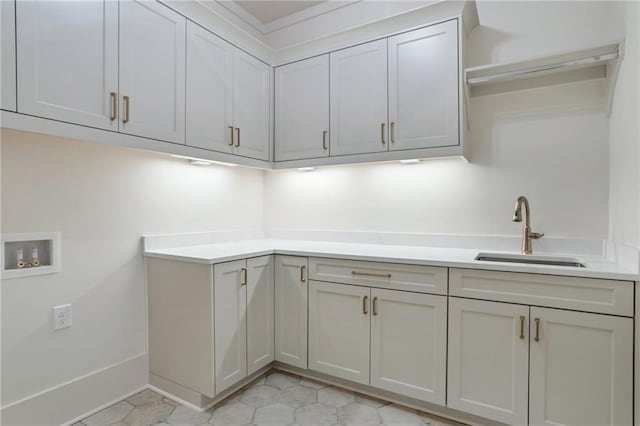 laundry room featuring washer hookup, sink, and cabinets