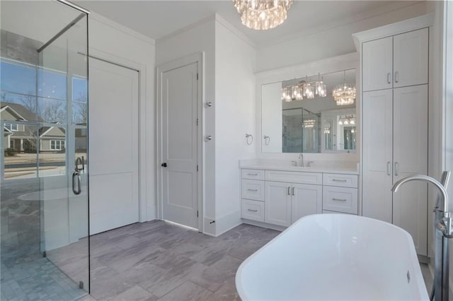 bathroom with ornamental molding, plus walk in shower, a notable chandelier, and vanity