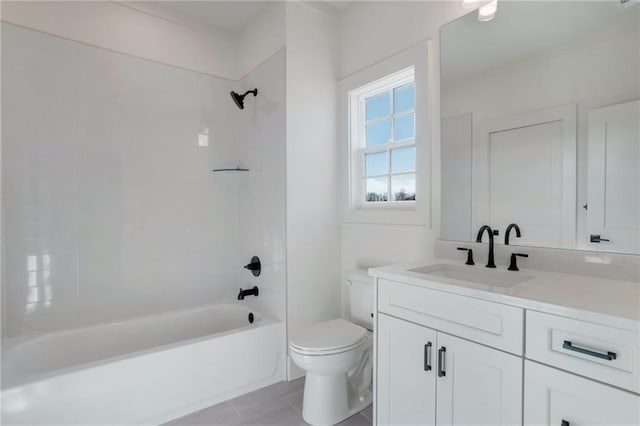 full bathroom with vanity, tiled shower / bath combo, and toilet