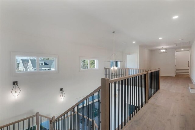 hall featuring a chandelier and light wood-type flooring