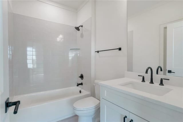 full bathroom featuring tiled shower / bath, vanity, and toilet