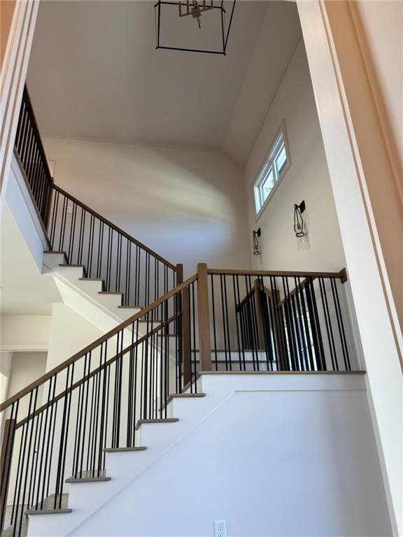 stairway with high vaulted ceiling