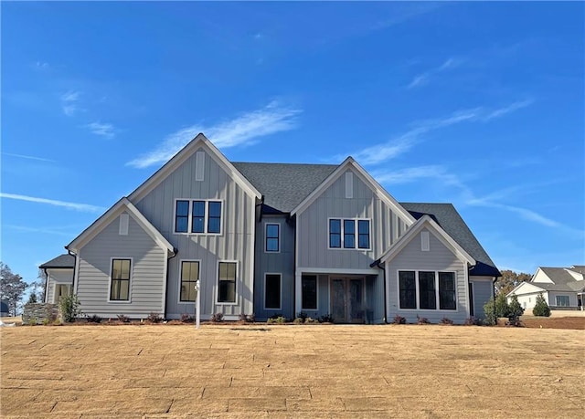 rear view of property featuring a lawn