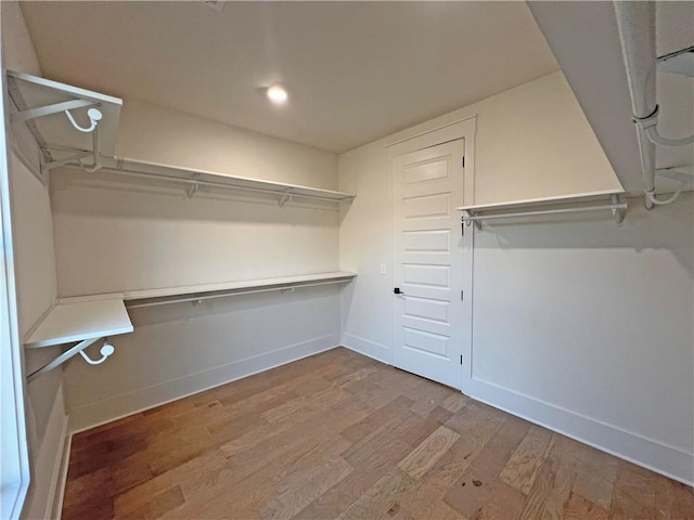 spacious closet with light hardwood / wood-style floors