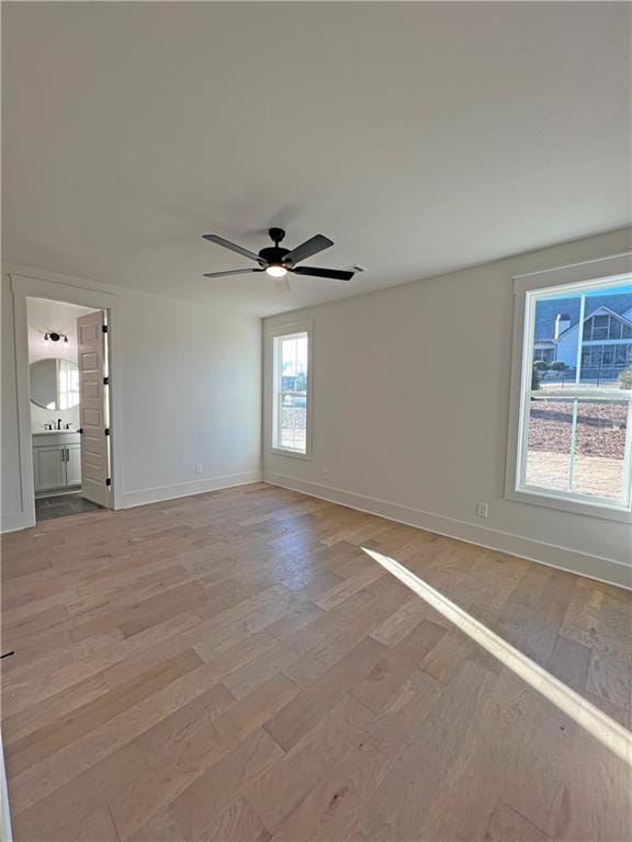 spare room with ceiling fan and light hardwood / wood-style flooring