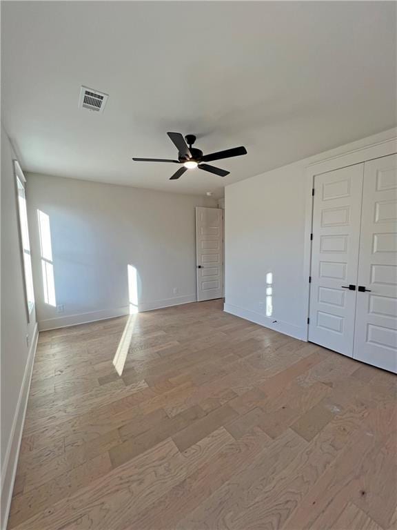 unfurnished room with ceiling fan and light hardwood / wood-style flooring