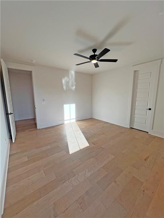 unfurnished bedroom with ceiling fan and light hardwood / wood-style flooring