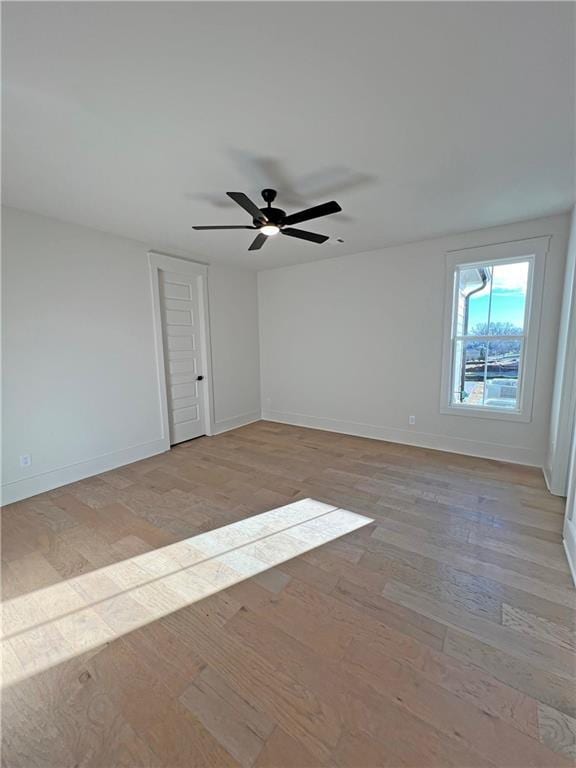 spare room featuring ceiling fan and light hardwood / wood-style floors