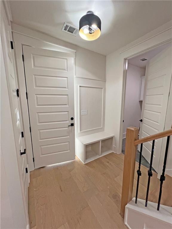 mudroom with light hardwood / wood-style floors