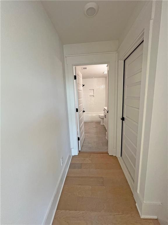 corridor with light wood-type flooring