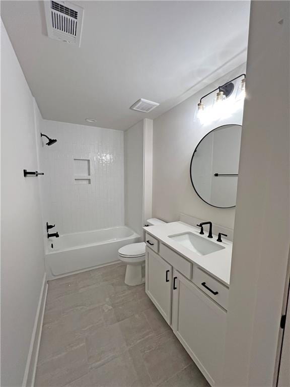 full bathroom with toilet, vanity, and tiled shower / bath