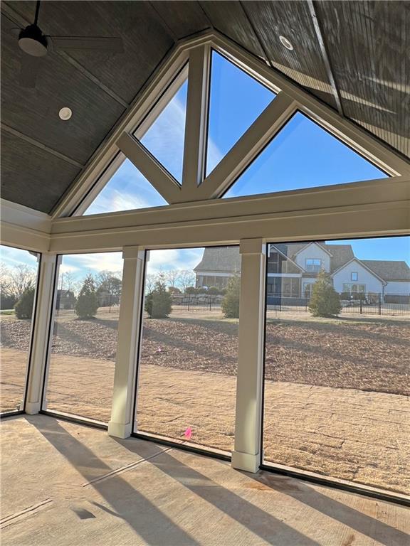 doorway featuring lofted ceiling and carpet floors