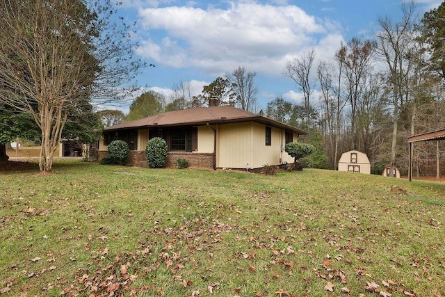 view of home's exterior with a storage unit and a lawn