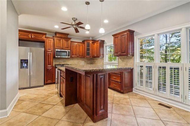 kitchen with ornamental molding, light tile patterned floors, tasteful backsplash, light stone counters, and stainless steel appliances