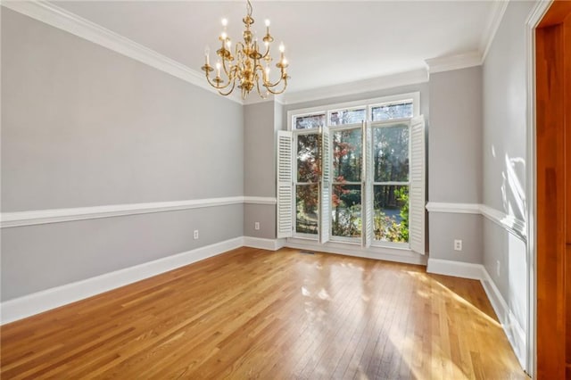 unfurnished dining area featuring a notable chandelier, ornamental molding, and light hardwood / wood-style flooring