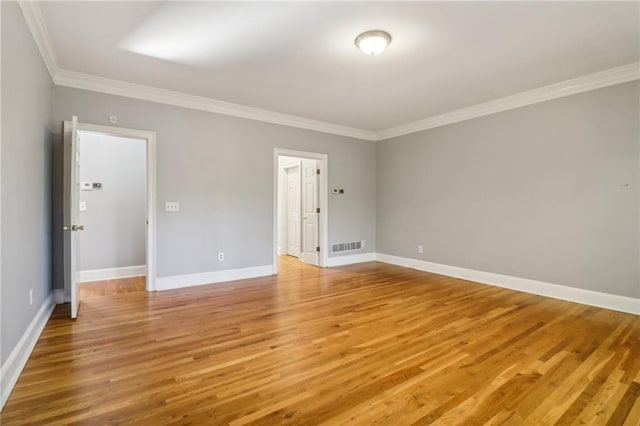 unfurnished room featuring wood-type flooring and crown molding