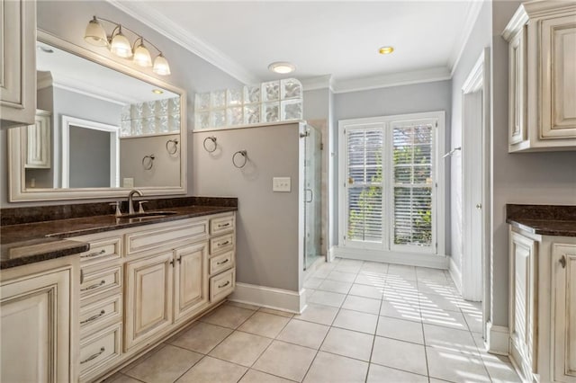 bathroom with tile patterned floors, crown molding, vanity, and walk in shower