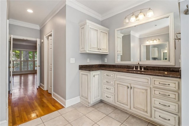 bathroom featuring hardwood / wood-style floors, vanity, and crown molding