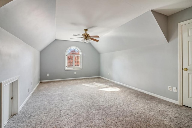additional living space featuring light colored carpet, vaulted ceiling, and ceiling fan