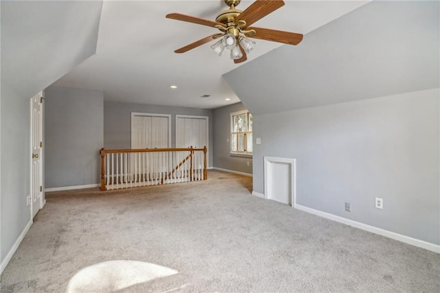 bonus room with ceiling fan, light colored carpet, and vaulted ceiling