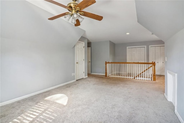 bonus room with ceiling fan, light colored carpet, and vaulted ceiling
