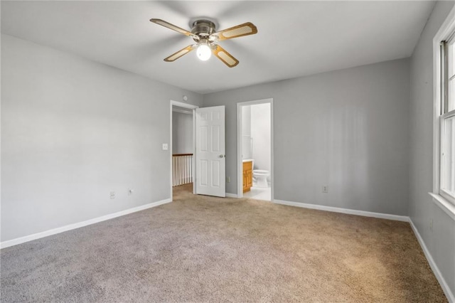 unfurnished bedroom with light carpet, ensuite bath, and ceiling fan
