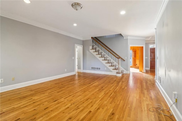 unfurnished room with light hardwood / wood-style floors and crown molding
