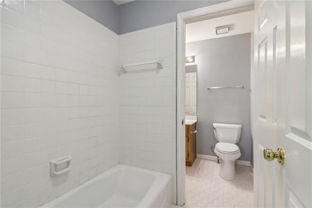 full bathroom with tile patterned floors, tiled shower / bath, vanity, and toilet